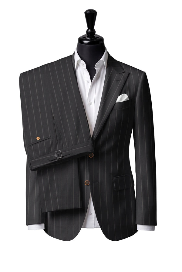 Two-button peak-lapel jacket with straight flap pockets. Trousers with side adjusters.