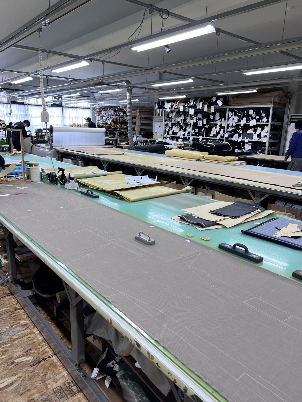 Cloth laid out and marked on the cutting tables at the Japan atelier